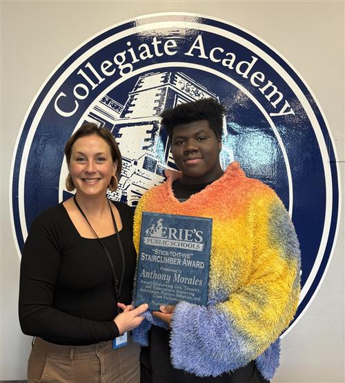 Anthony Morales, Collegiate's November Stairclimber, poses with a school staff member and his plaque.